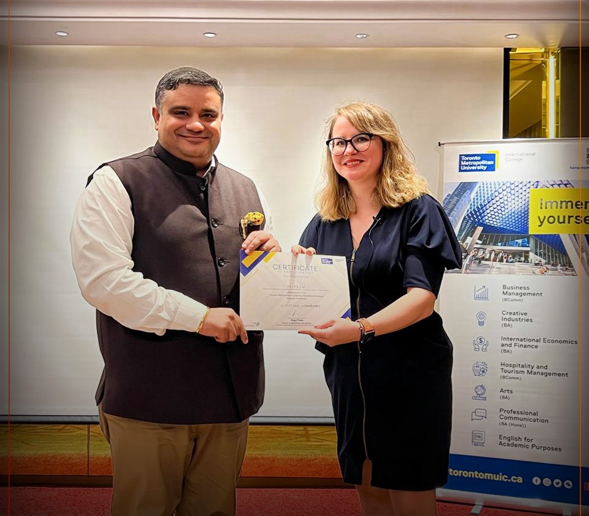 Mitesh Malhotra receiving Toronto Metropolitan University recognition award