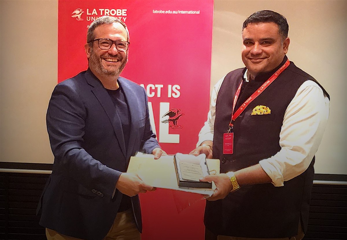 Mitesh Malhotra receiving La Trobe University recognition award